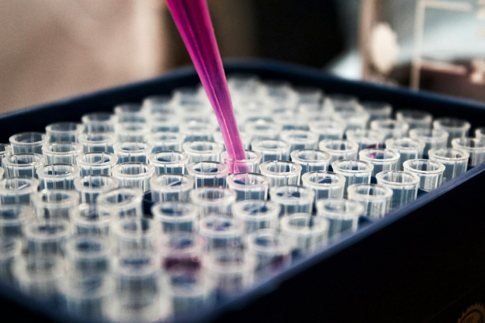 Purple looking liquid being poured into beakers. 