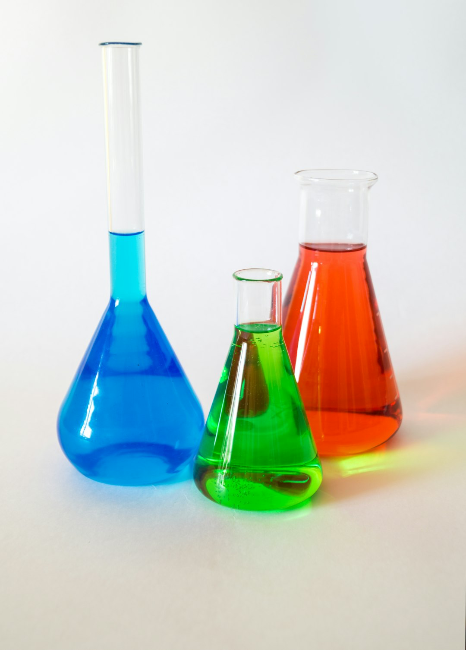 Beakers filled with blue, green, and red liquids