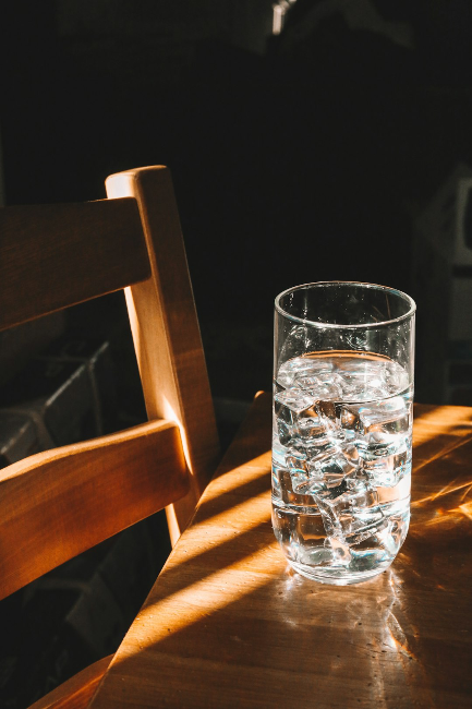 Tall glass of water on a wooden table