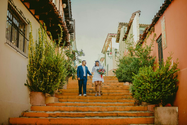 Bride and groom waking down the stairs