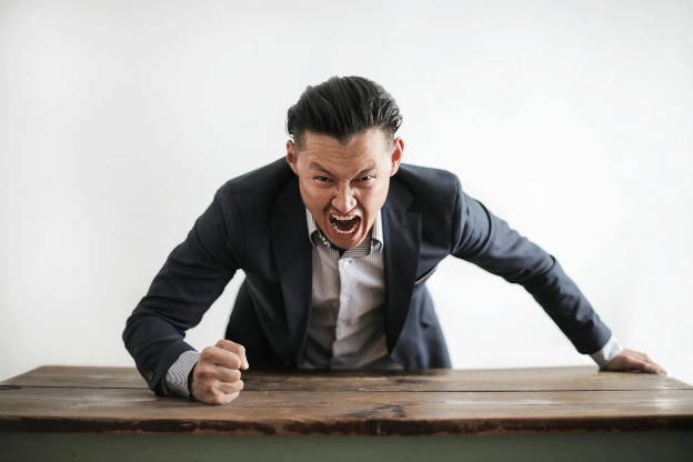 Man angry slamming his hand on a table