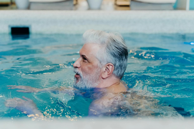 Middle-aged man swimming in a pool