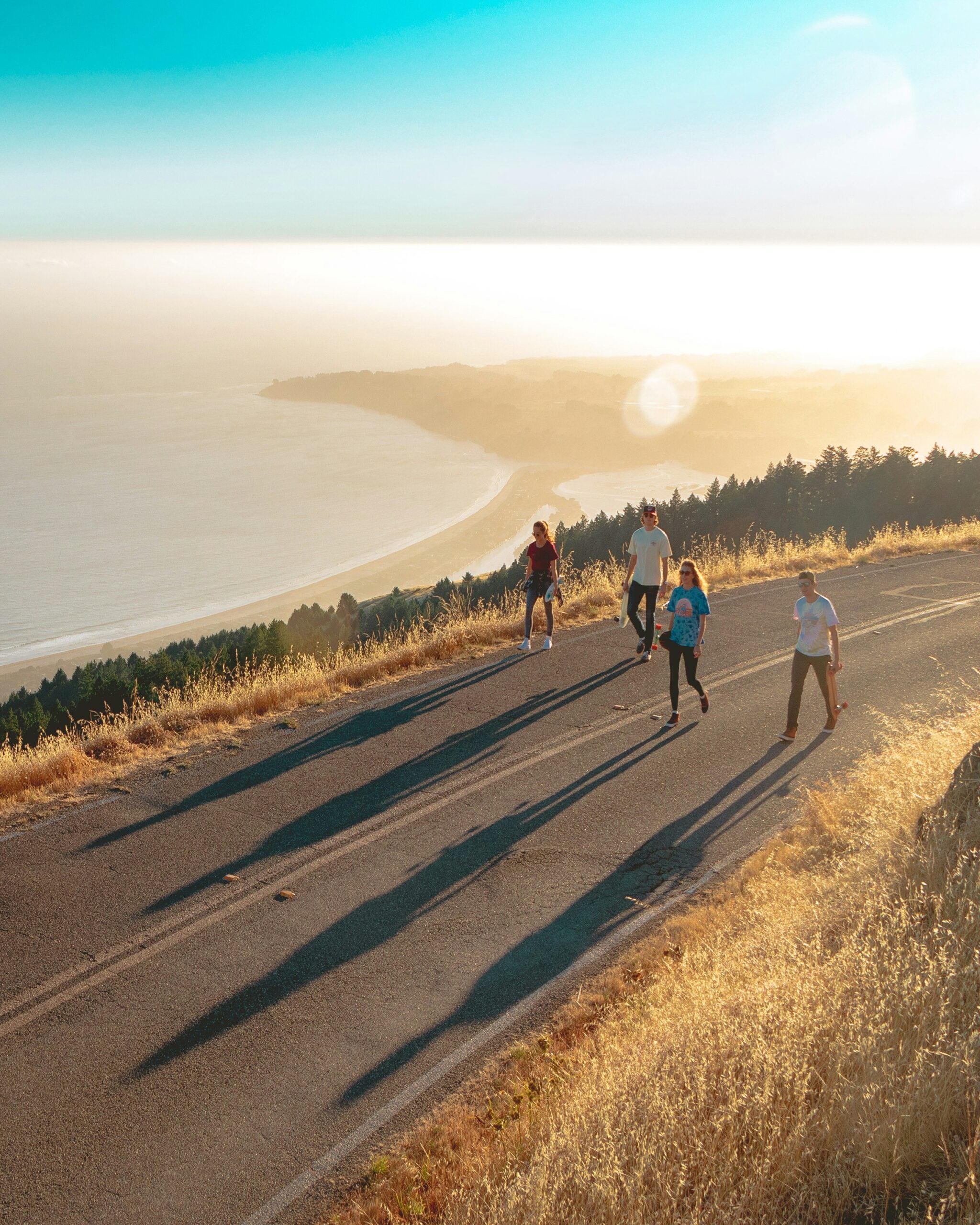 During sunset, people walking down a road to stay fit